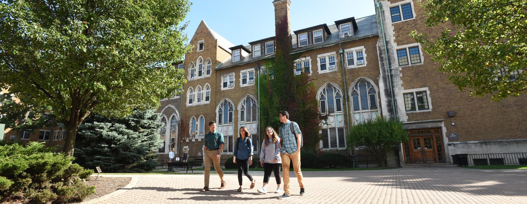 Four students ealkiong on campus