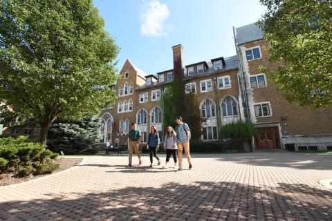 Four students ealkiong on campus