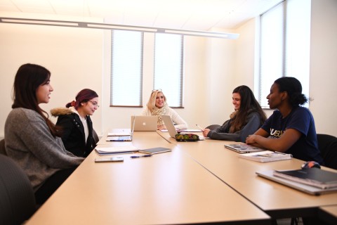 Five females meetingb at a table