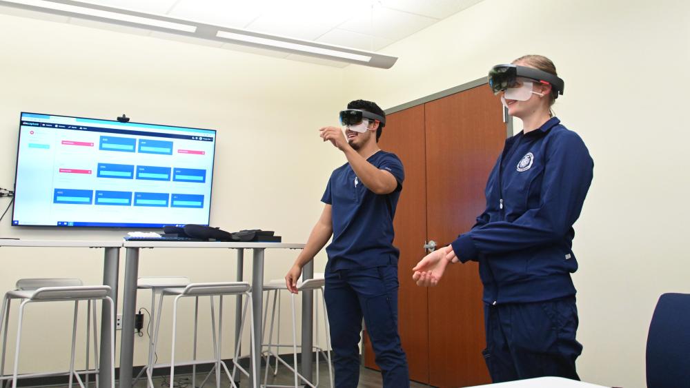 Dominican University students using virtual reality headsets in a classroom.