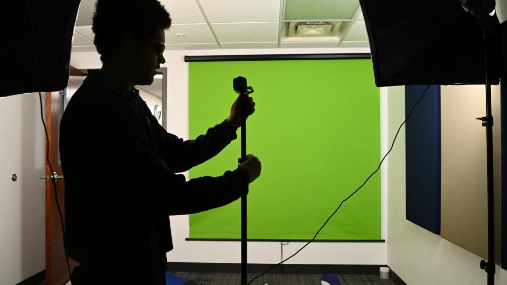 Student using green screen in studio