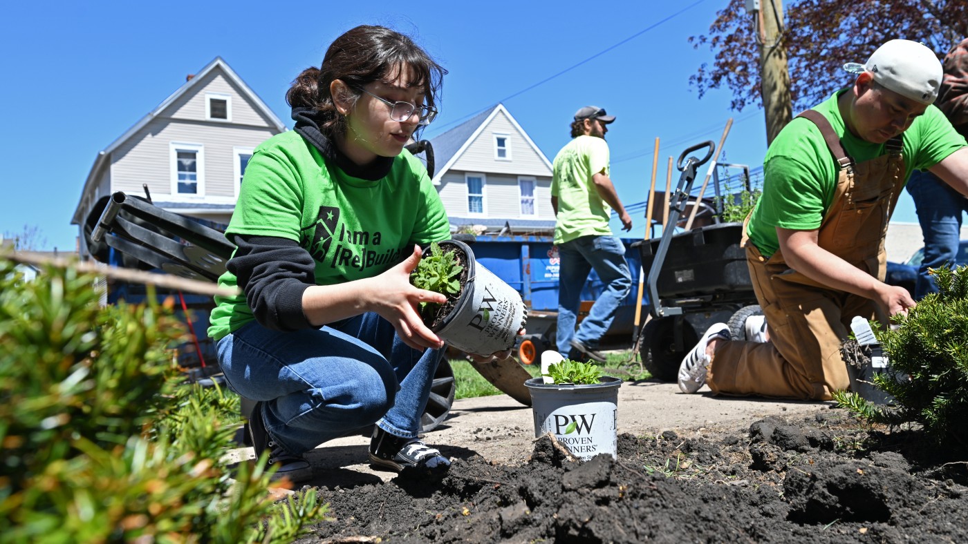 Dominican students planting greenery as part of National Rebuilding Day, helping a Maywood family improve their home and property.