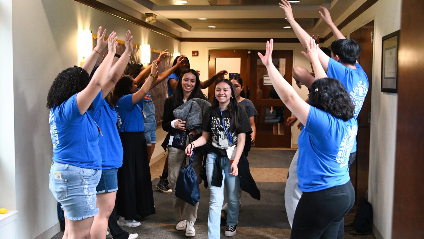 Students moving through aisle of students