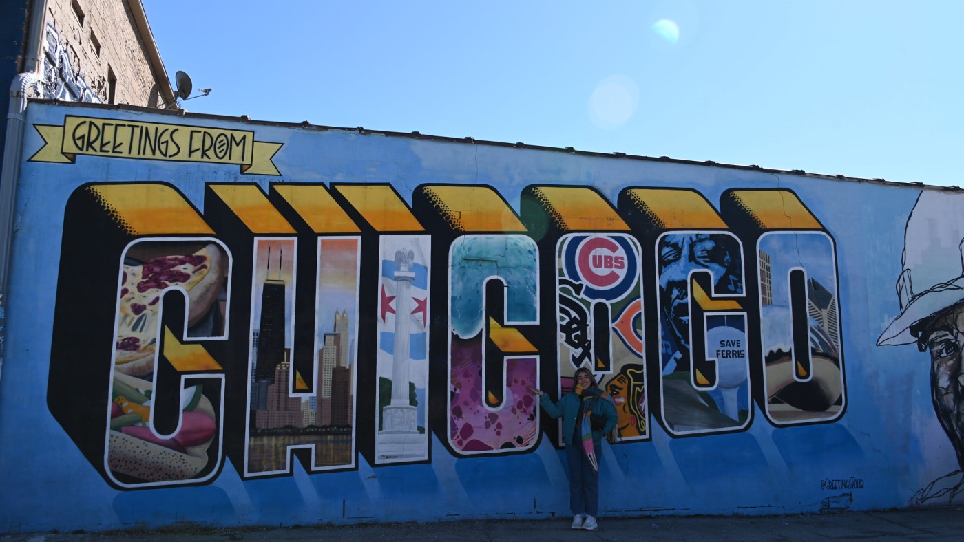 Students standing in front of Greetings from Chicago ABI Mural