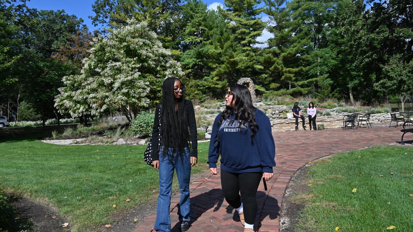 Two female students walking on campus