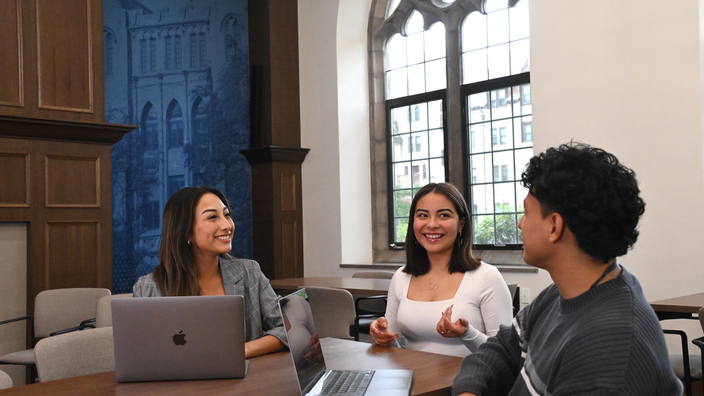 Three students meeting at a table