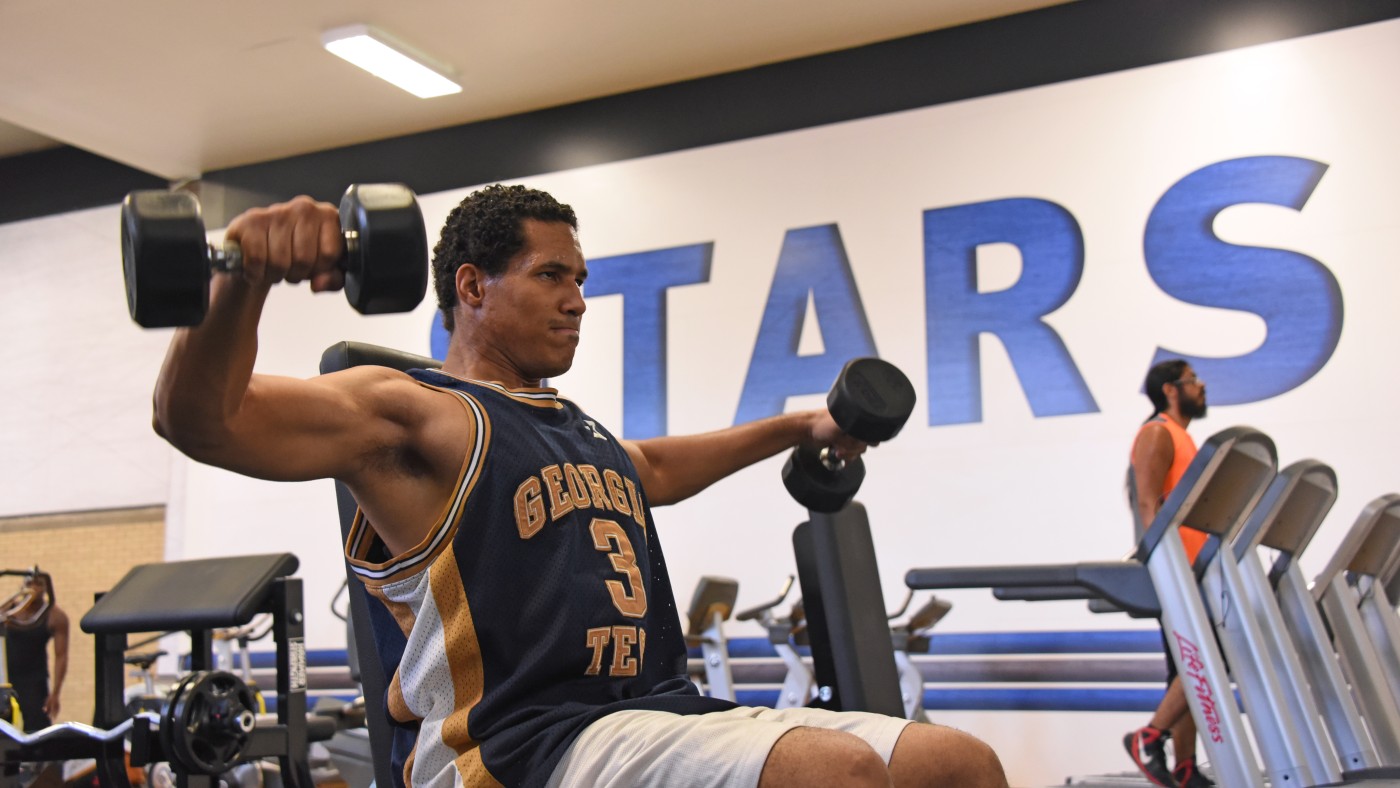 A student uses free weights in dominican University's Fitness Center.
