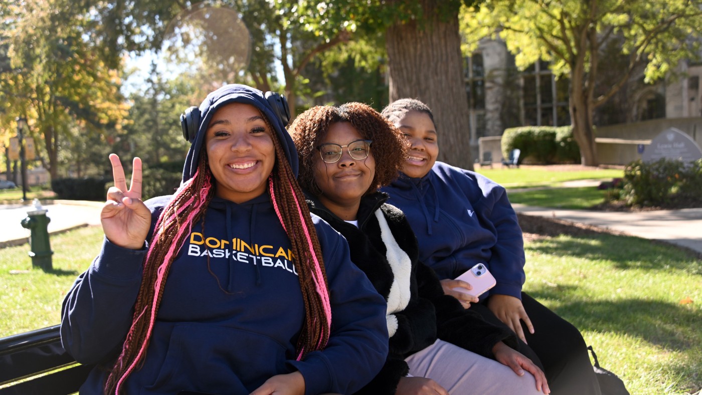 Three female students on a bench