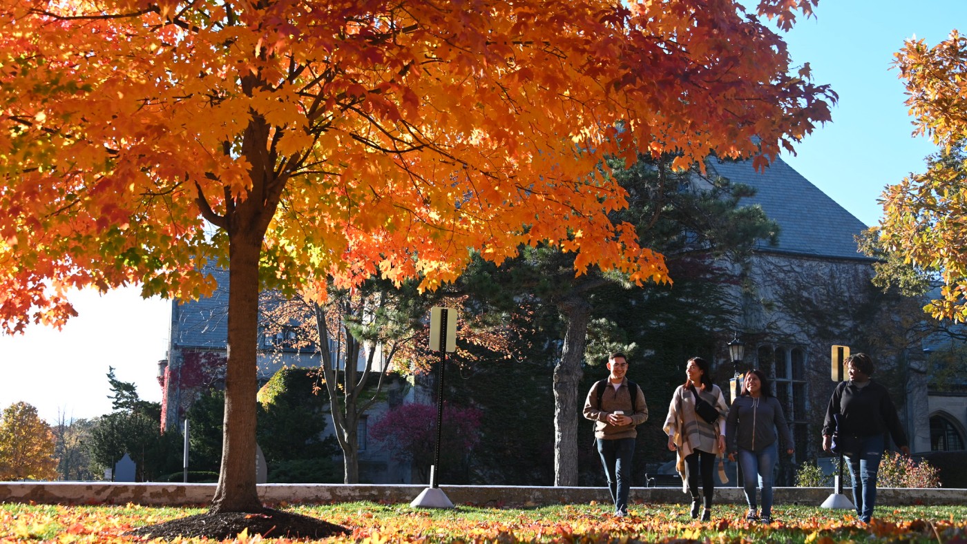 Students walking on campus in the fall