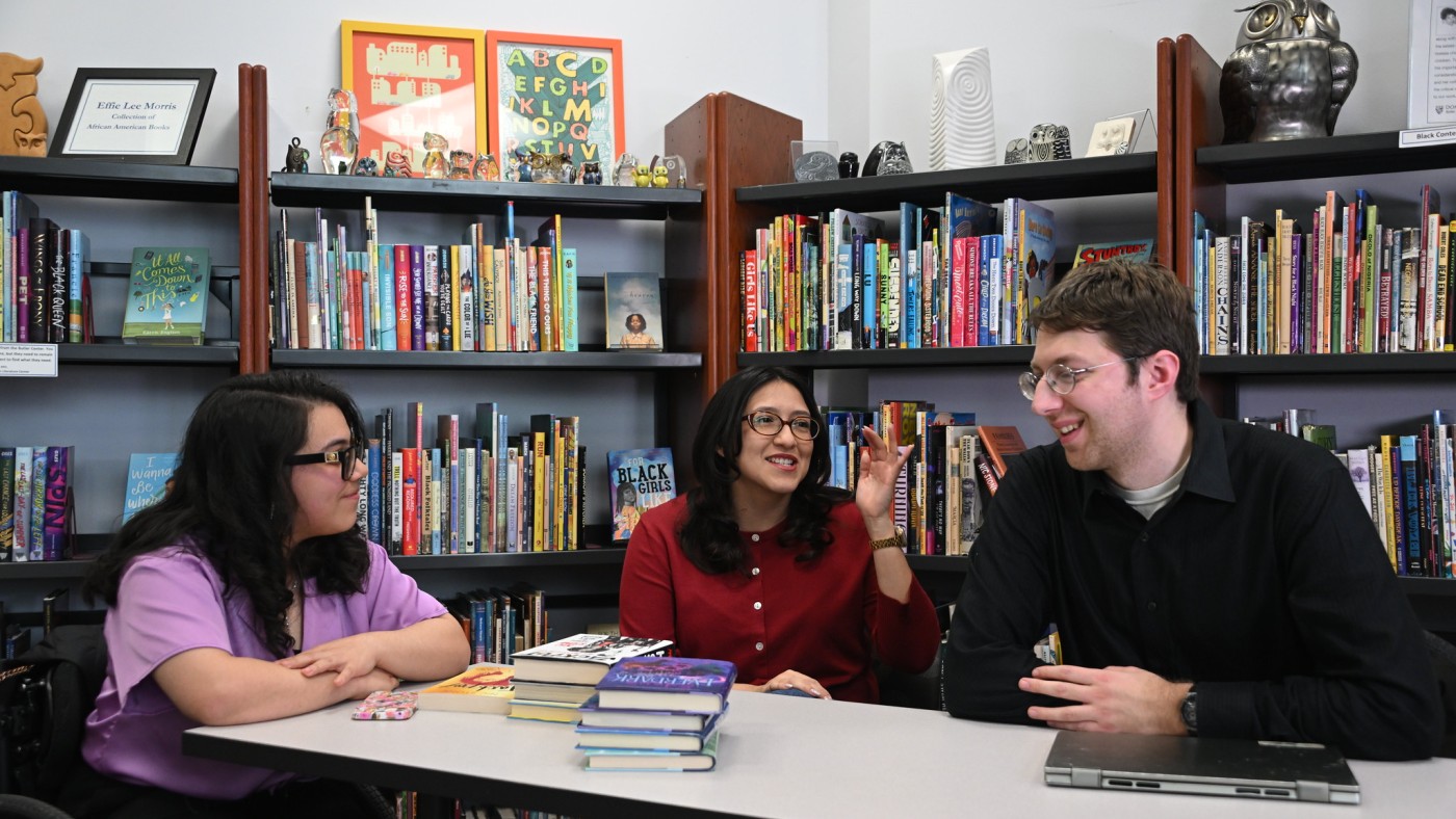 Three students working at a table