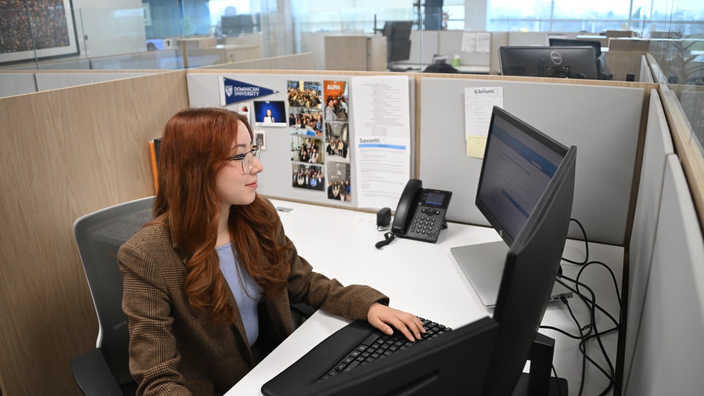 Female in office setting with laptop