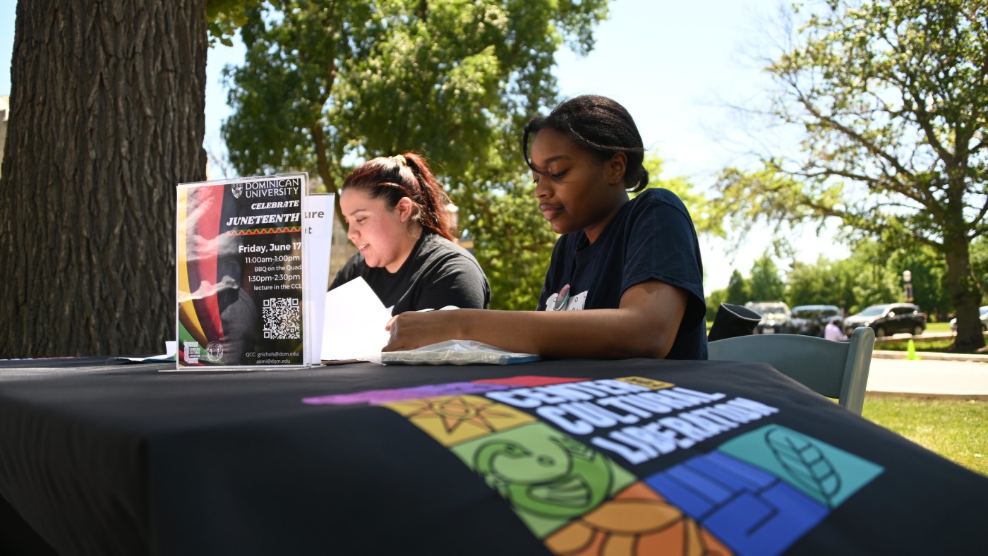 Students sitting at a table outside