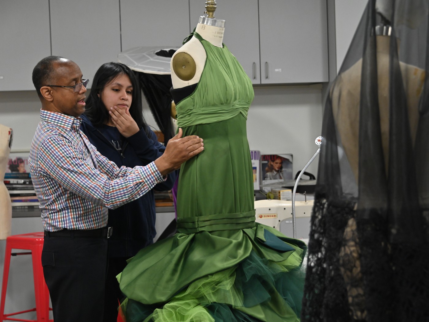 A professor and student work on a garment in Dominican University's Fashion Lab.