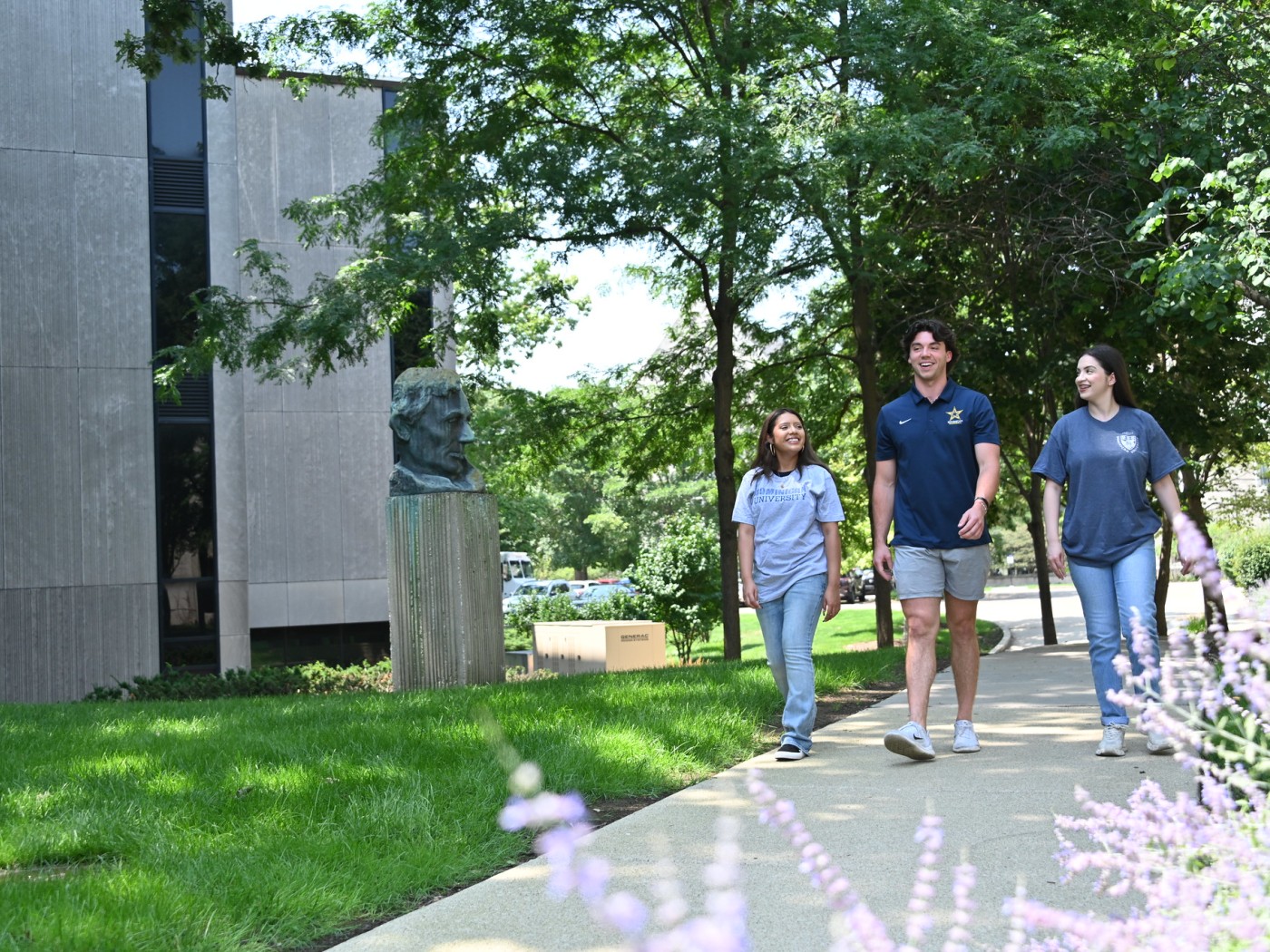 Three students walking on campus