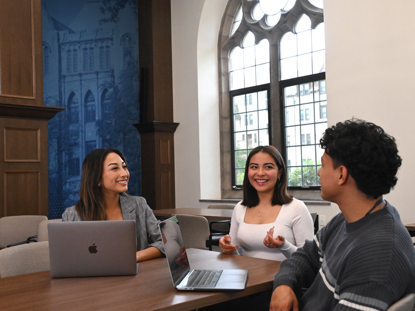 Three students meeting at a table