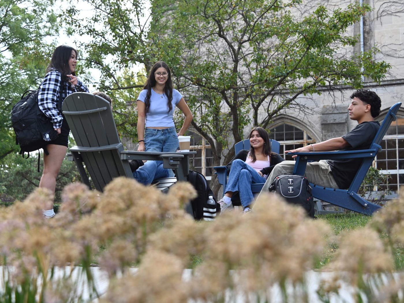 Students seated outdoors on campus