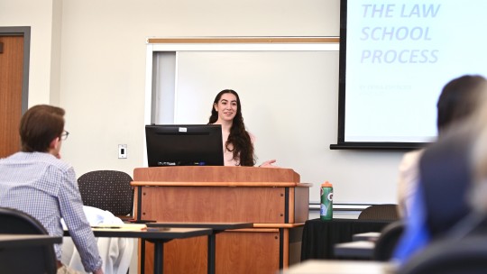 Student presenting at podium