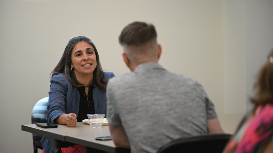 Angela Cardenas in discussion with another PhD student.