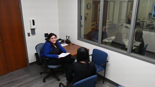 Student interviewing in lab