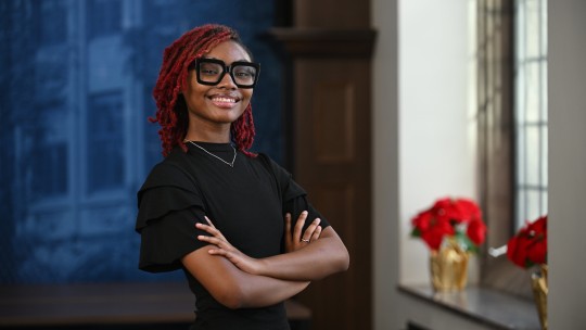 Portrait of Gabirelle White standing by a window