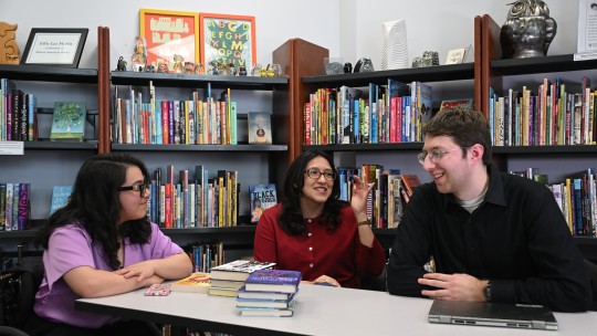 Three students working at a table