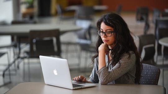Female student using laptop